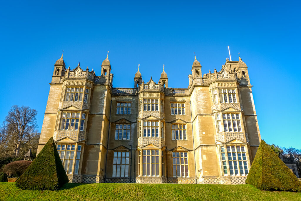 The grand mansion House of Englefield is one of the most beautiful historic houses in England. The grounds are lined with beautiful toparies and the beautiful sandstone building was used as the filming location of various films, including Cruella.