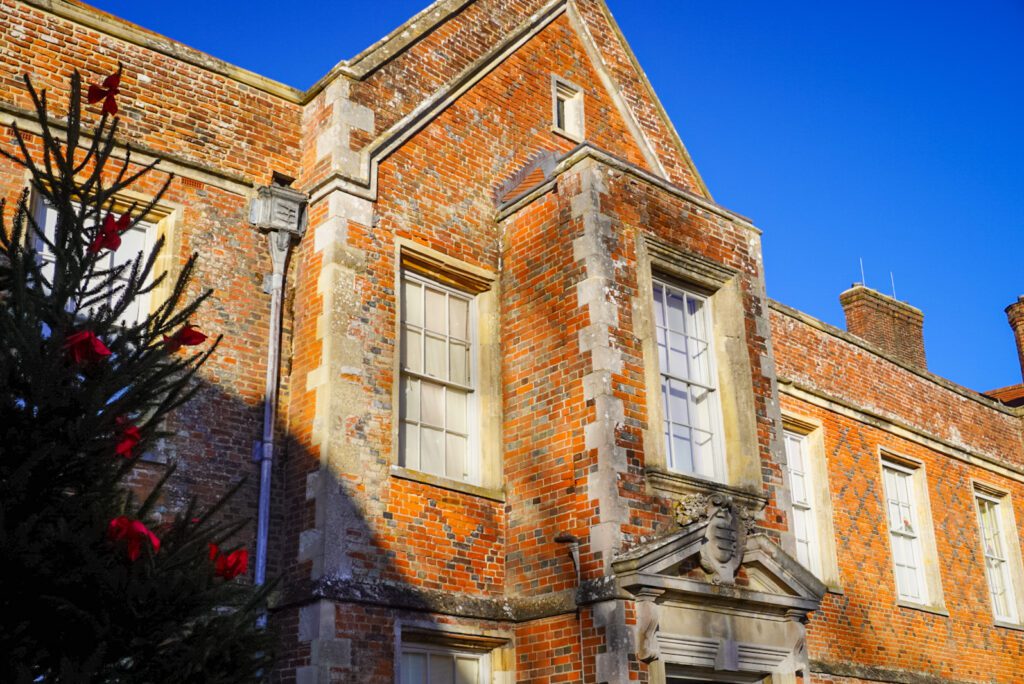 The red brick mansion of the Vyne is a 16th century historic house, located in the heart of the Hampshire countryside. The mansion house is located next to a walled garden, a river flowing through the property and a small bridge, crossing over a weir.