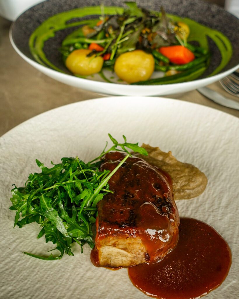 A picture of an aubergine steak and a rocket and potato salad at the top floor of the Atomium in Brussels. It is possible to dine in the restaurant.