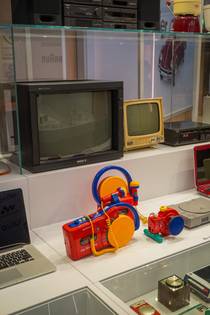 A picture of the Design Museum, a free day out idea in London. On display is a collection of old tvs and radios, from black and white to colourful geometric designs, which take you through the history of design in the United Kingdom.