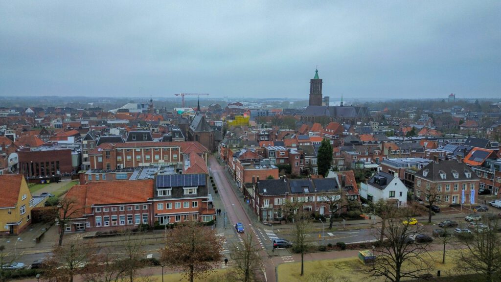 An aerial view of the city of Venlo, one of the most cycling-friendly cities in the Netherlands. The drone photo is taken on a foggy winters day with low clouds.