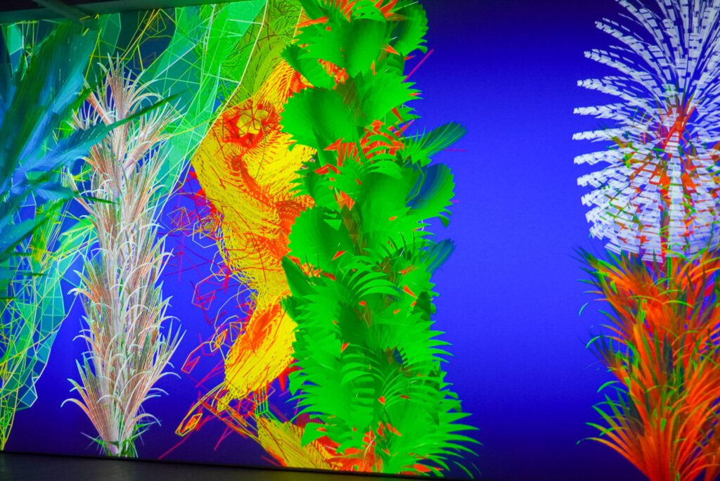 Bright green and yellow flowers dance on the LED screen of the digital garden at the flowers exhibition.