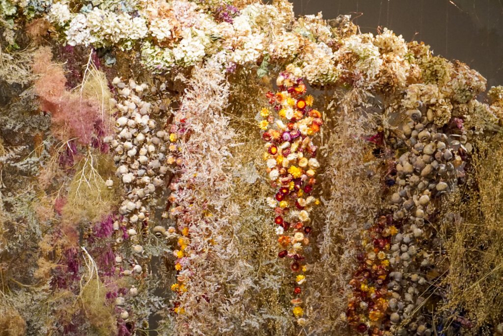 Over 100,000 colourful flowers are suspended in the air in the double-decker Saatchi Gallery. The exhibition showcases multi-coloured flora. The flowers hang down from the ceiling and you are able to walk between them and interact with the installation.