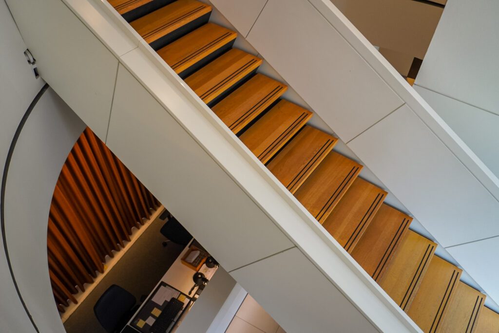 The Stadthotel has impressive architecture- with a wooden staircase with white railings crossing above the reception desk in the lobby of the hotel.